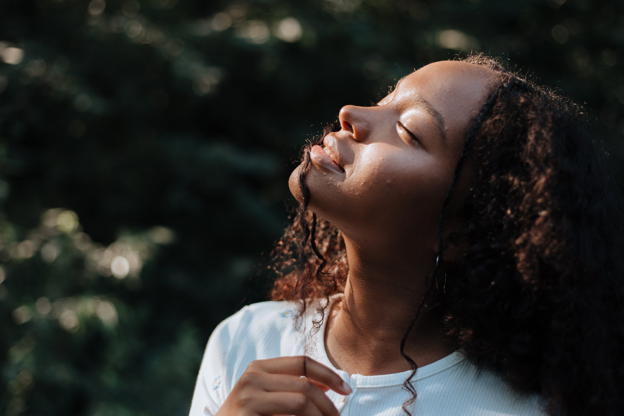 Teenage Girl Exposing Her Face to Sunlight